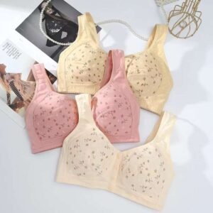 Five bras in pastel colors with floral designs displayed on a light background with fashion magazines.