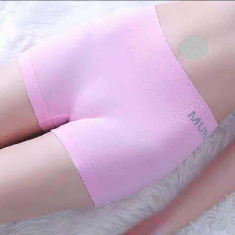 Close-up image of pink elastic shorts displayed on a soft surface.