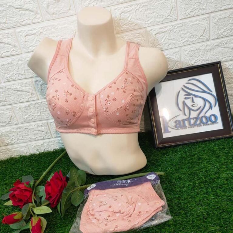 A display of a pink bra on a mannequin with floral embroidery, accompanied by matching panties and roses in the foreground.