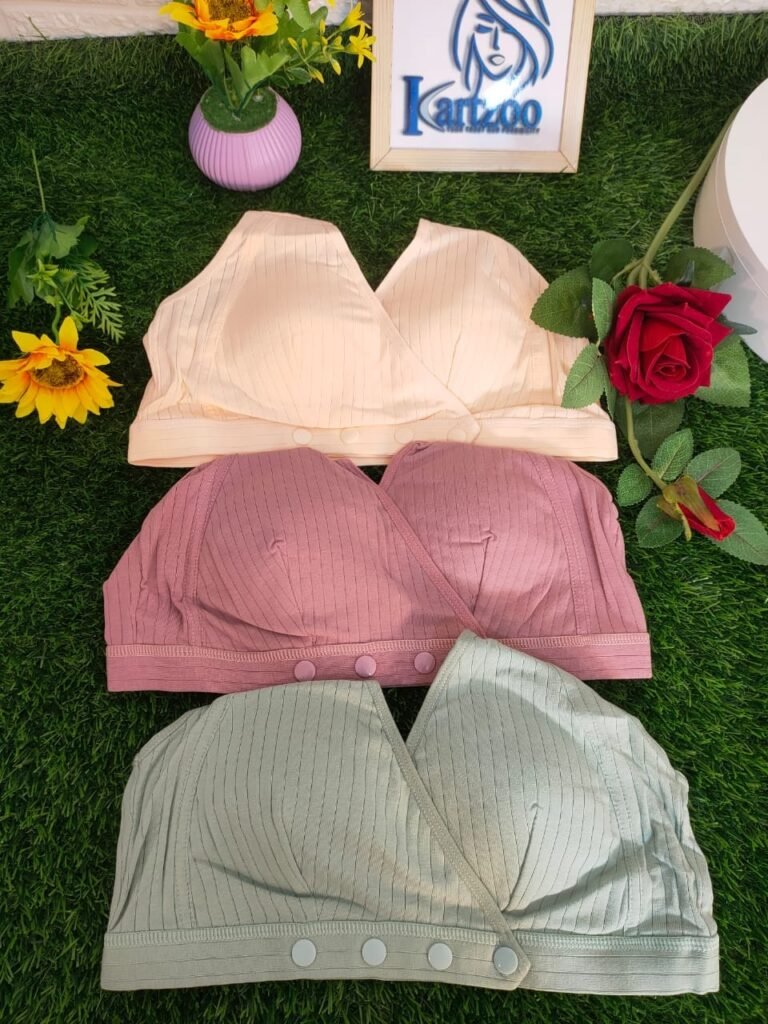 Three differently colored bras displayed on greenery: one in light yellow, one in light pink, and one in light green, with a decorative flower and a frame with a logo in the background.