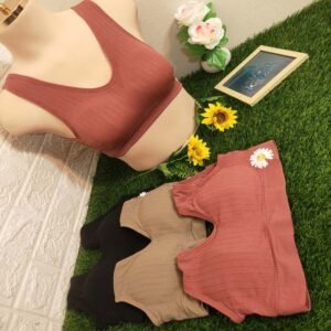 Three AirSoft bras in shades of rust, beige, and black displayed on a mannequin with decorative flowers and a photo frame.