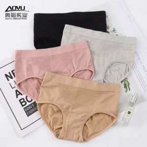 Four pairs of SoftFit Tummy Control Panties in black, pink, gray, and beige lying on a flat surface with a small bottle and magazine.