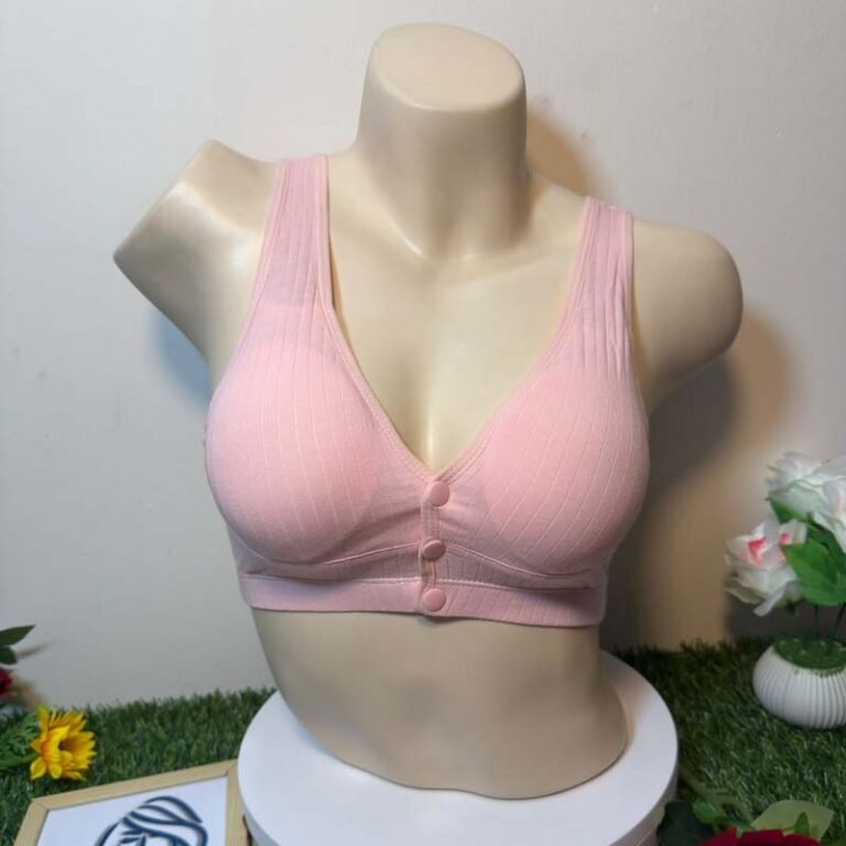 A pink bra displayed on a mannequin against a light background with decorative flowers.